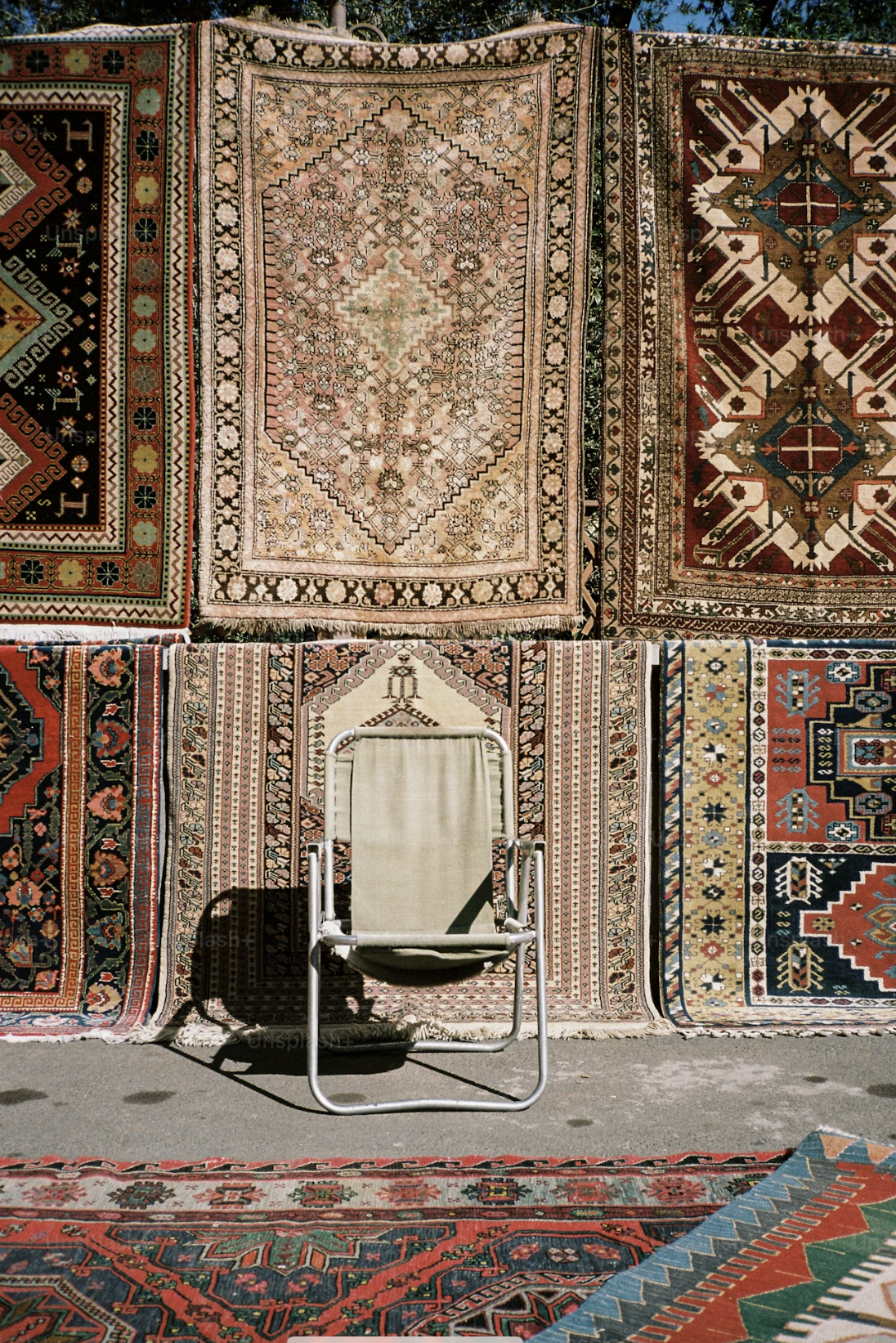 UNS — rugs displayed under open sky, made in Pakistan